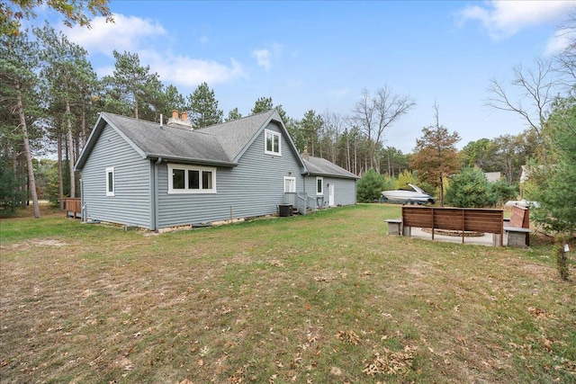 view of side of home with a lawn