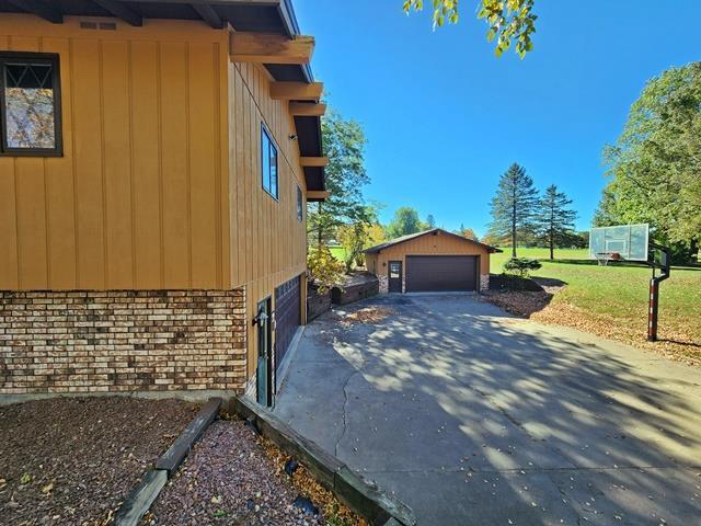 view of property exterior featuring an outbuilding and a garage