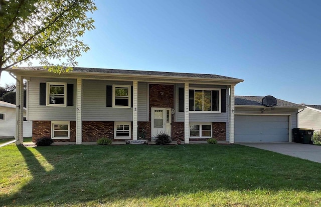 raised ranch featuring a front yard and a garage