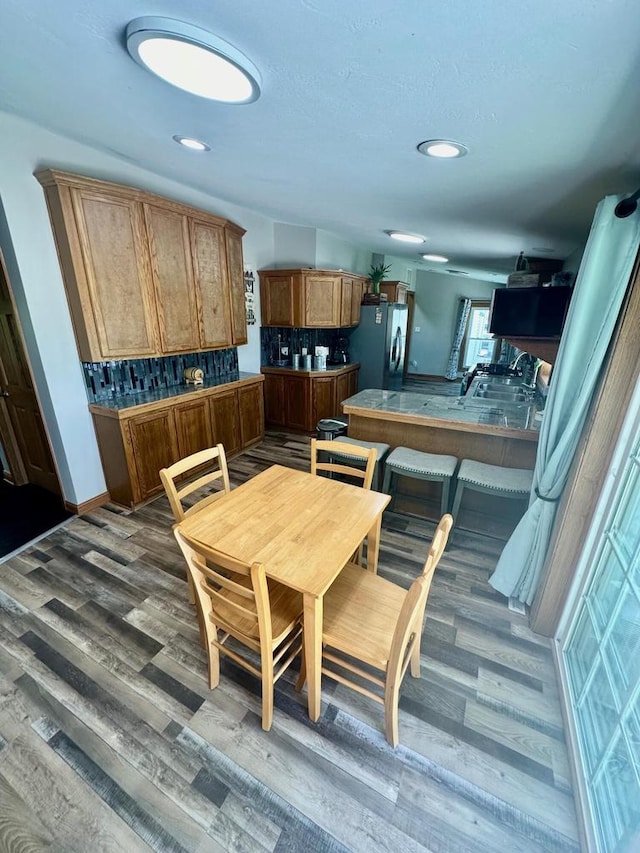 dining room with dark hardwood / wood-style flooring