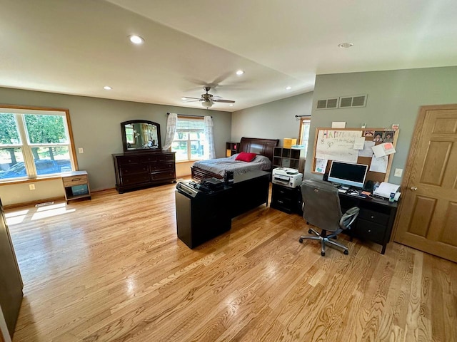 bedroom with vaulted ceiling, light hardwood / wood-style flooring, and ceiling fan