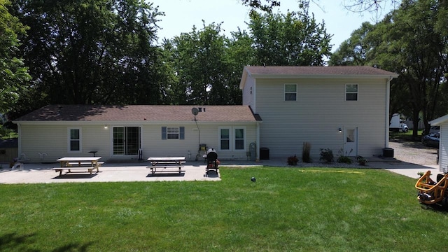 rear view of house featuring a patio and a lawn