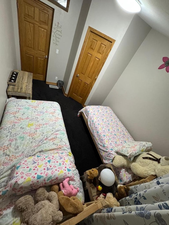 bedroom featuring dark colored carpet