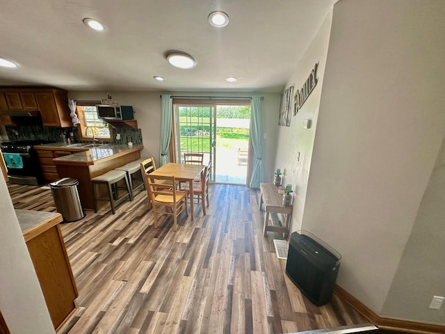 dining area with sink and light wood-type flooring