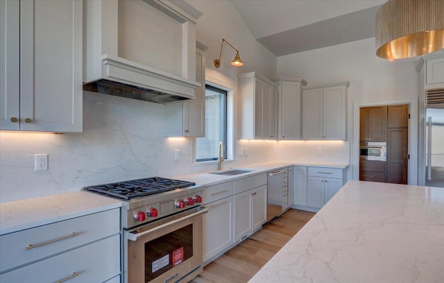 1438 Greenleaf Ct, Sun Prairie, WI 53590 - kitchen featuring light stone counters, white cabinetry, backsplash, appliances with stainless steel finishes, and a sink