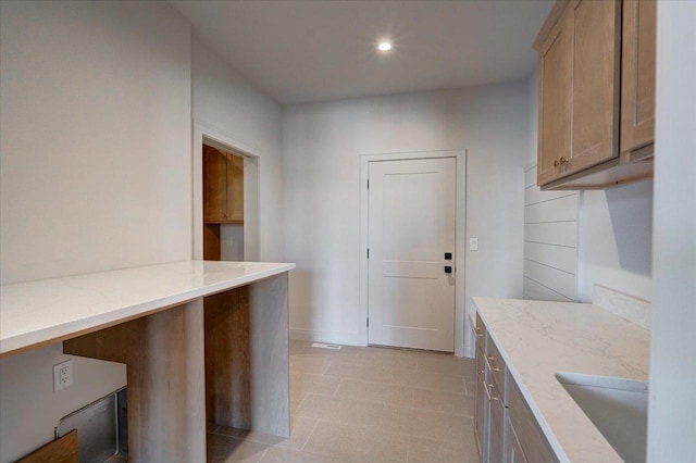 1438 Greenleaf Ct, Sun Prairie, WI 53590 - kitchen with a sink, recessed lighting, and light stone countertops