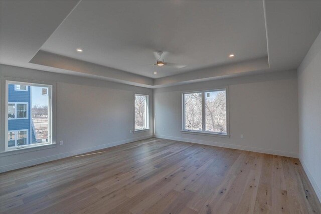 1438 Greenleaf Ct, Sun Prairie, WI 53590 - spare room with baseboards, recessed lighting, a tray ceiling, ceiling fan, and light wood finished floors