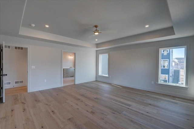 1438 Greenleaf Ct, Sun Prairie, WI 53590 - unfurnished bedroom with visible vents and a tray ceiling
