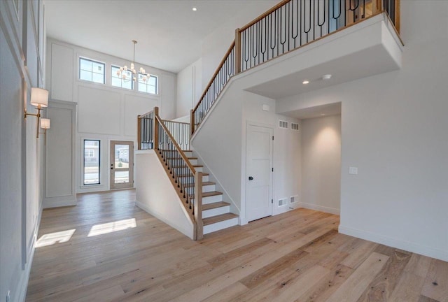 1438 Greenleaf Ct, Sun Prairie, WI 53590 - foyer entrance with a wealth of natural light, a notable chandelier, wood finished floors, and stairs