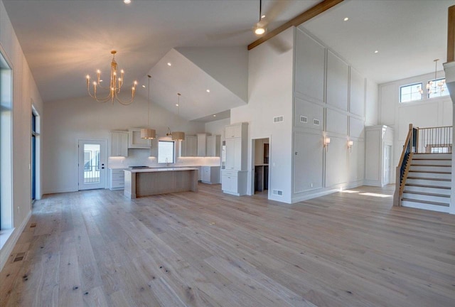 1438 Greenleaf Ct, Sun Prairie, WI 53590 - kitchen featuring open floor plan, high vaulted ceiling, a chandelier, and visible vents