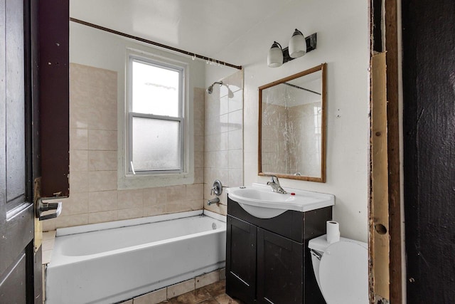 full bathroom with tiled shower / bath combo, vanity, and toilet