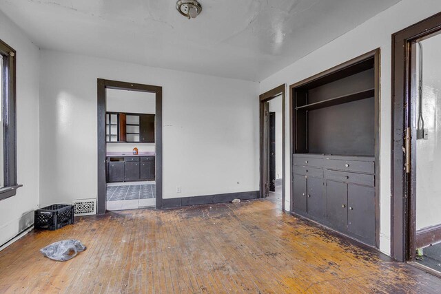 unfurnished bedroom with dark hardwood / wood-style flooring