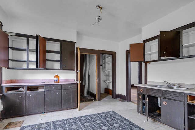 kitchen with dark brown cabinetry and sink