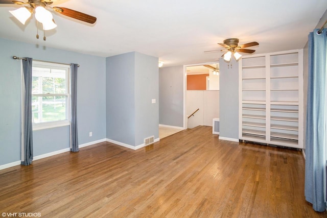 spare room with hardwood / wood-style flooring and ceiling fan