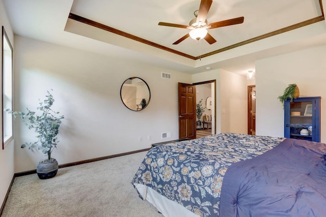 bedroom with a raised ceiling, ornamental molding, and ceiling fan