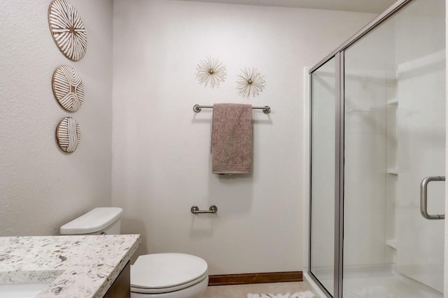 bathroom with walk in shower, vanity, and toilet