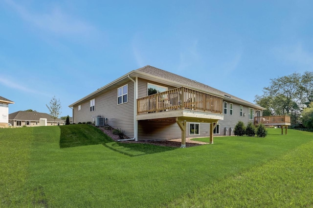 rear view of property with a deck, central air condition unit, and a lawn