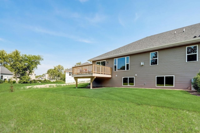 back of house with a wooden deck and a lawn