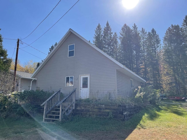 view of side of home with a lawn