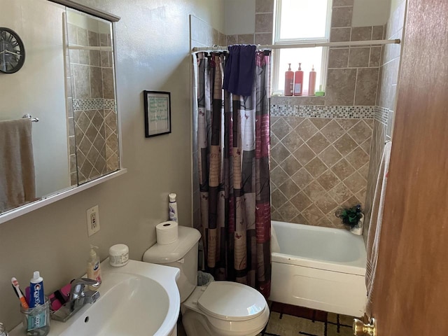 full bathroom featuring shower / tub combo with curtain, sink, and toilet