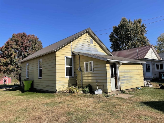 back of property featuring a lawn