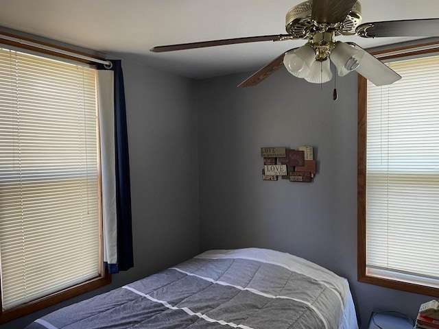 bedroom featuring multiple windows and ceiling fan