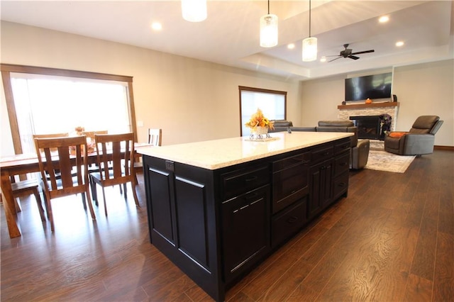 kitchen with decorative light fixtures, dark hardwood / wood-style floors, and plenty of natural light