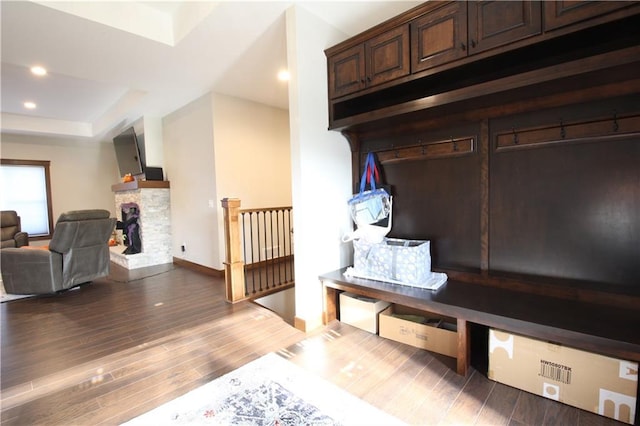 mudroom featuring a stone fireplace and hardwood / wood-style floors