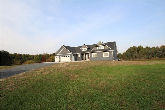 view of front of house featuring a front yard and a garage