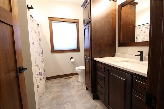 bathroom featuring toilet and vanity