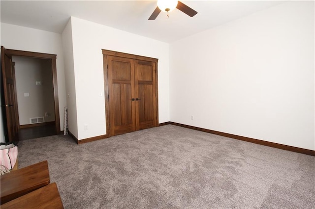 unfurnished bedroom with ceiling fan and carpet flooring