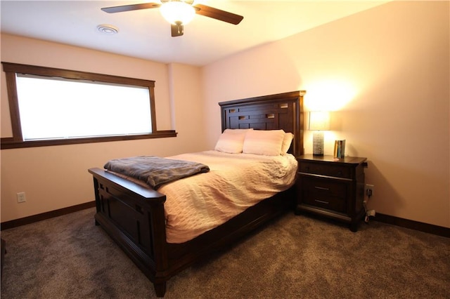 bedroom with ceiling fan and dark colored carpet