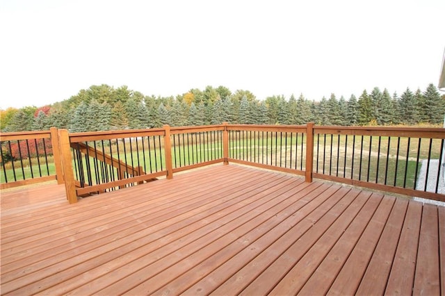 wooden terrace featuring a yard