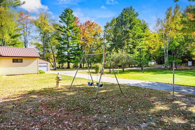 view of playground with a lawn and an outdoor structure