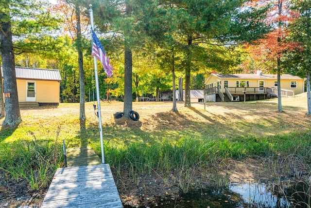 view of yard featuring a deck with water view