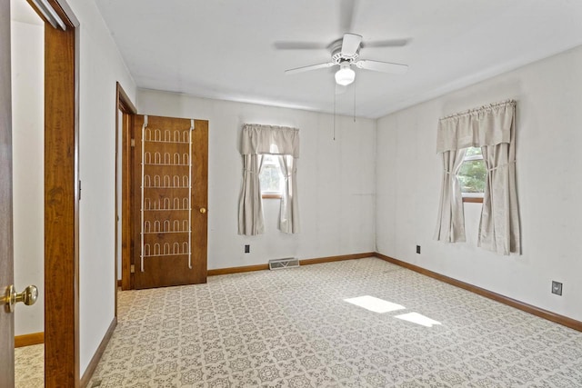 unfurnished room with ceiling fan and a healthy amount of sunlight