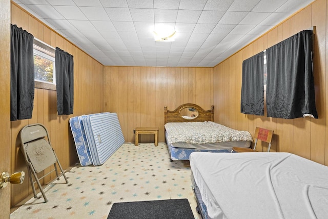 bedroom featuring wooden walls