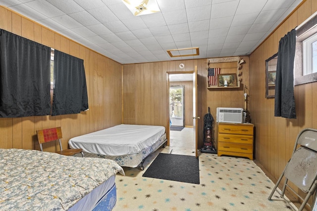 bedroom with wooden walls and multiple windows