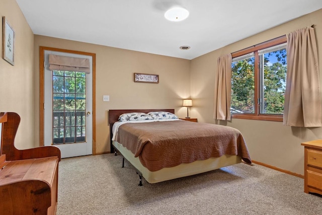 carpeted bedroom with access to outside and multiple windows