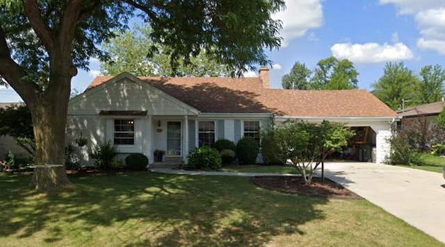 view of front of home with a front yard and a garage