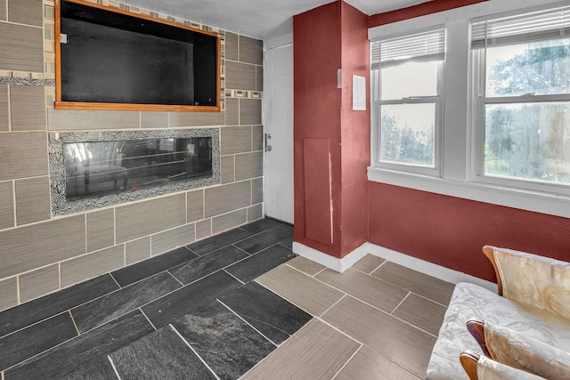 bathroom featuring a healthy amount of sunlight and a tile fireplace