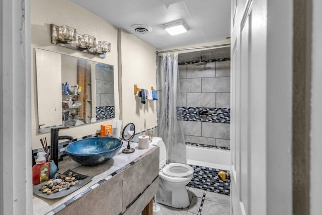 full bathroom with tile patterned floors, vanity, shower / tub combo with curtain, and toilet