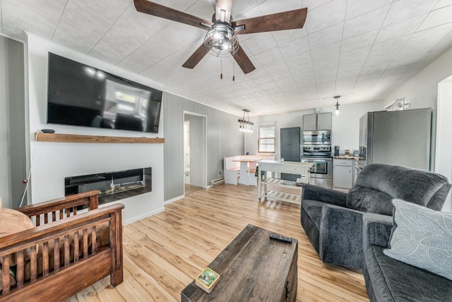 living room featuring ceiling fan and light wood-type flooring