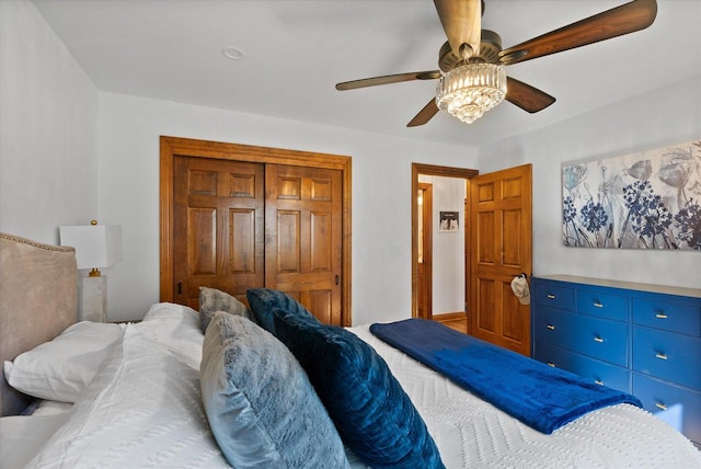 bedroom with ceiling fan and a closet