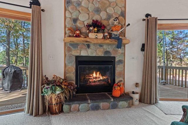 room details with a stone fireplace and carpet flooring