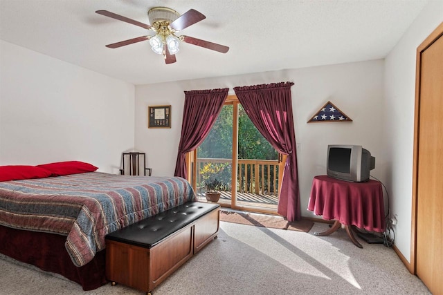 bedroom featuring access to exterior, light colored carpet, a textured ceiling, and ceiling fan