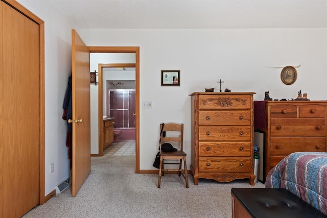 carpeted bedroom featuring connected bathroom