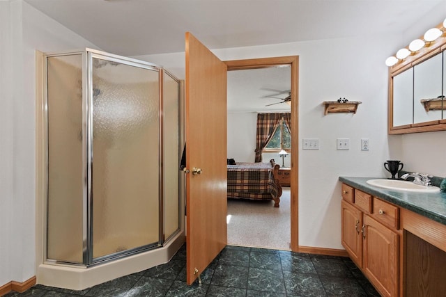 bathroom featuring ceiling fan, vanity, and a shower with shower door