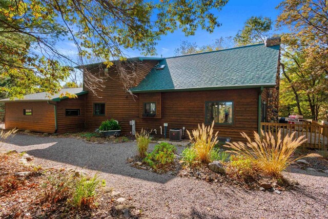 331 Robindale Ct, Nekoosa, WI 54457 - back of house with a chimney, central AC unit, and roof with shingles