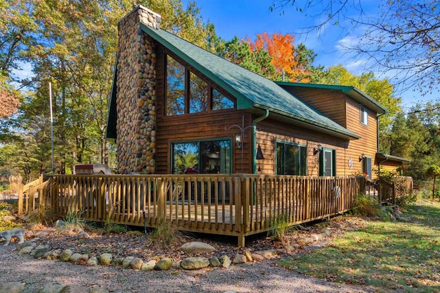 view of property exterior featuring a wooden deck